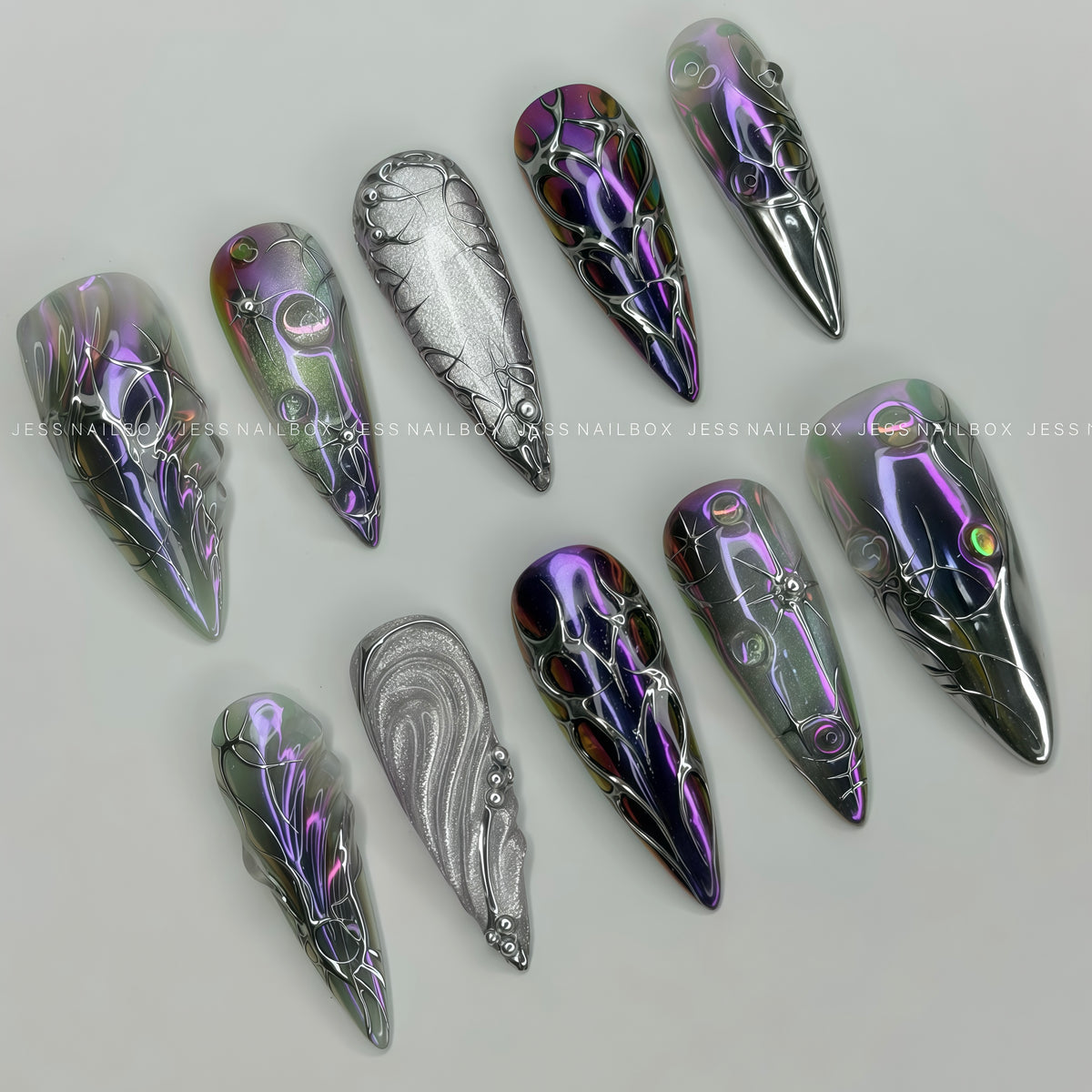 Void Protocol - Handcrafted Cyberpunk Alien-Inspired Press-On Nail Set Displayed at an Angle Showing 3D Liquid Silver Art and Cosmic Circles