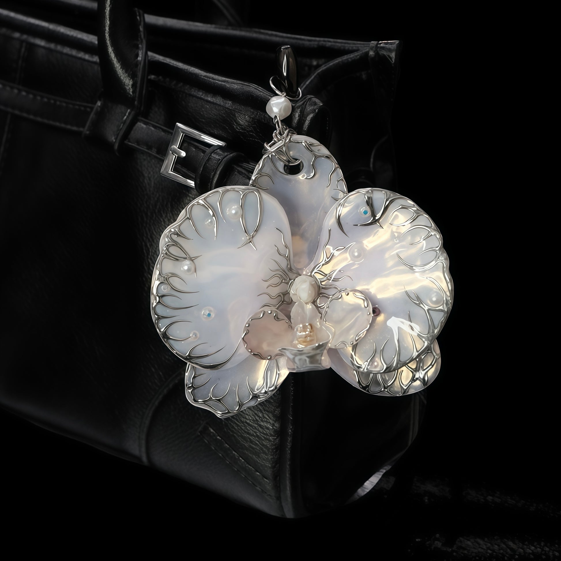 Cyber Petal - High-Fashion Pearl-Inlaid Orchid Charm Styled on a Black Leather Designer Tote Bag