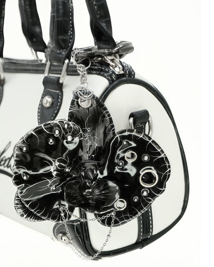 Orchid.exe - High-Fashion Handcrafted Black Resin Orchid Charm Styled on a Leather Bowler Bag