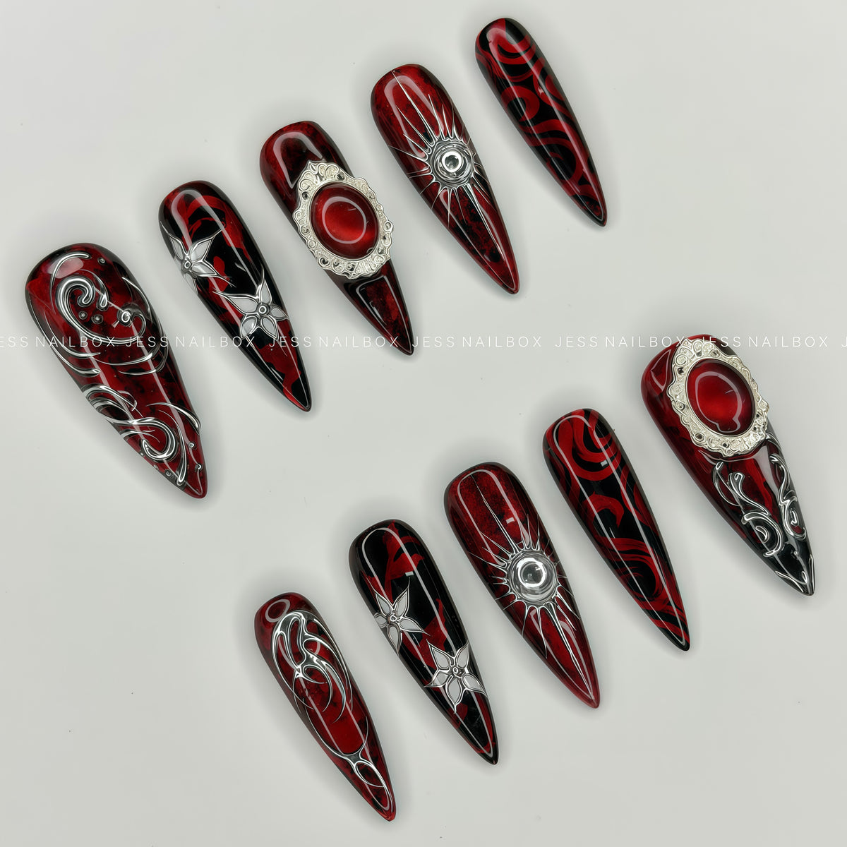 Vampire Glam - Handcrafted Crimson Red Cat-Eye and 3D Silver Chrome Tribal Lines Press-On Nail Set Displayed at an Angle